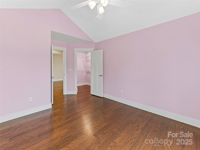 unfurnished room with a ceiling fan, baseboards, lofted ceiling, and wood finished floors