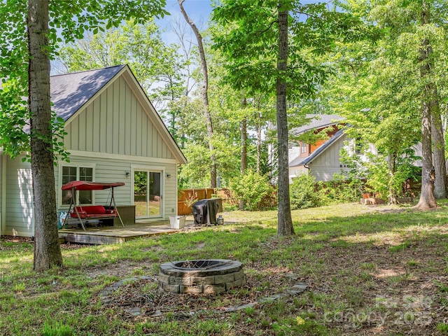 view of yard featuring an outdoor fire pit and a wooden deck