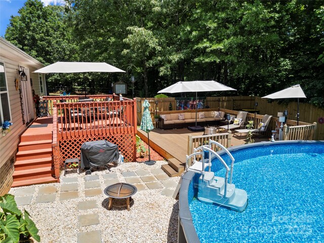5764 Grassy Creek Rd, Denver, NC 28037 - view of pool featuring a deck, an outdoor living space with a fire pit, a fenced backyard, and area for grilling