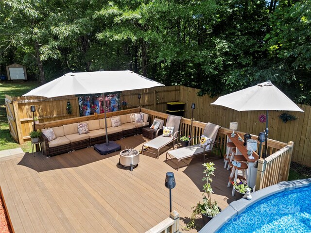 5764 Grassy Creek Rd, Denver, NC 28037 - wooden deck with an outdoor living space, fence, a shed, and an outbuilding