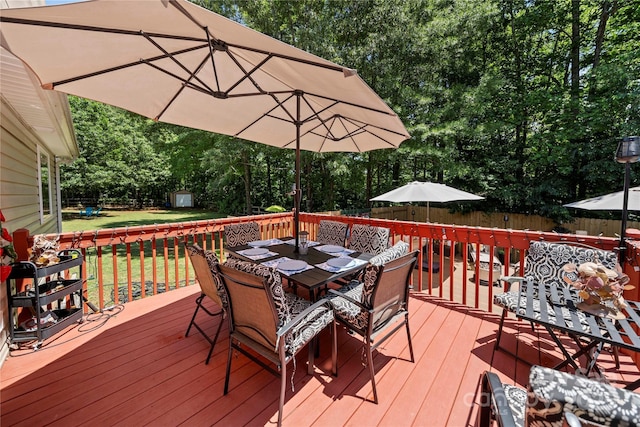 5764 Grassy Creek Rd, Denver, NC 28037 - wooden terrace featuring outdoor dining area, a shed, an outbuilding, and view of wooded area