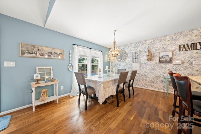 5764 Grassy Creek Rd, Denver, NC 28037 - dining room featuring wallpapered walls, baseboards, a chandelier, and wood finished floors