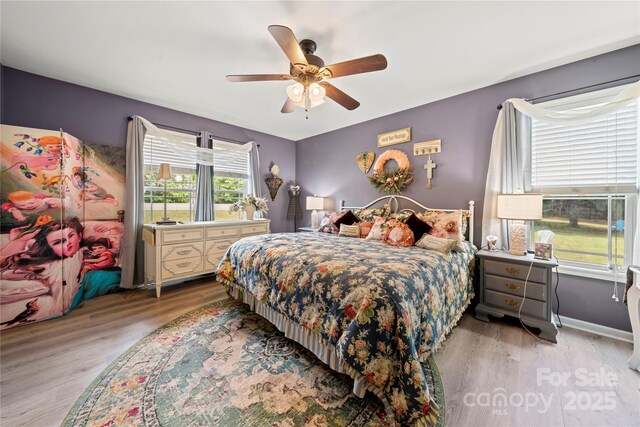 5764 Grassy Creek Rd, Denver, NC 28037 - bedroom featuring light wood-style flooring, a ceiling fan, and baseboards