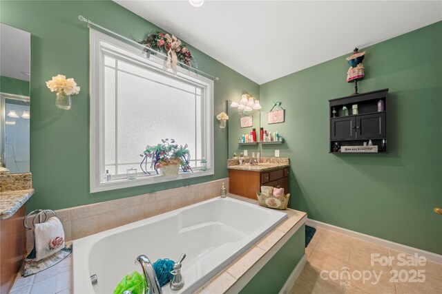 5764 Grassy Creek Rd, Denver, NC 28037 - bathroom featuring vanity, a garden tub, tile patterned flooring, and baseboards