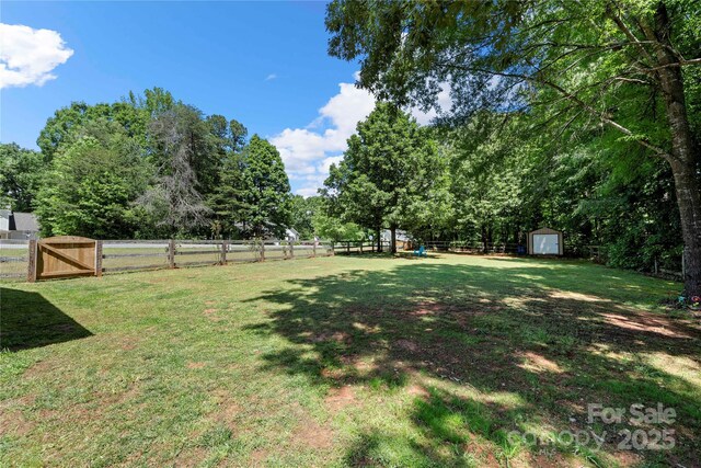 5764 Grassy Creek Rd, Denver, NC 28037 - view of yard with a storage shed, an outbuilding, and a gate