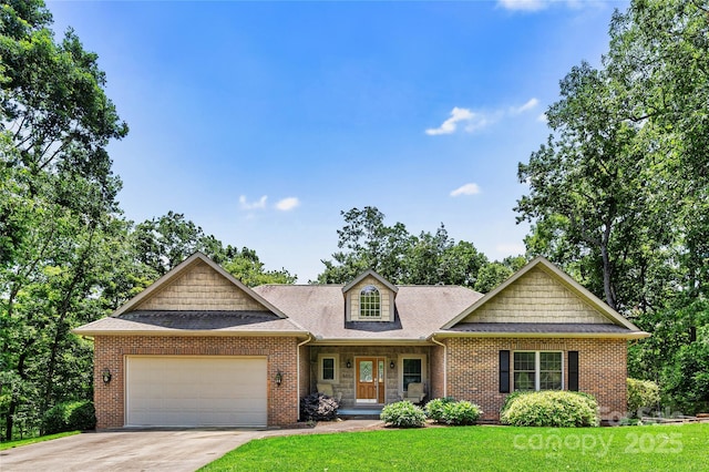 view of front facade with an attached garage, a front yard, concrete driveway, and brick siding