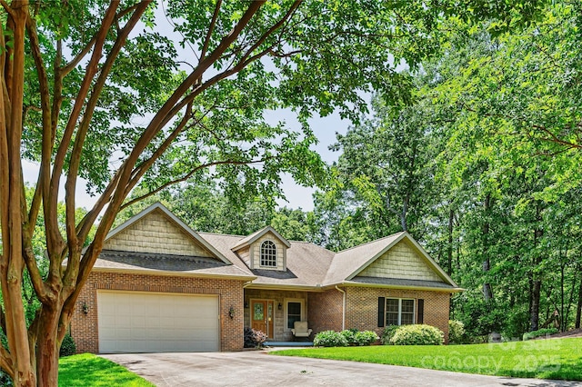 view of front of property with an attached garage, concrete driveway, brick siding, a front yard, and a shingled roof