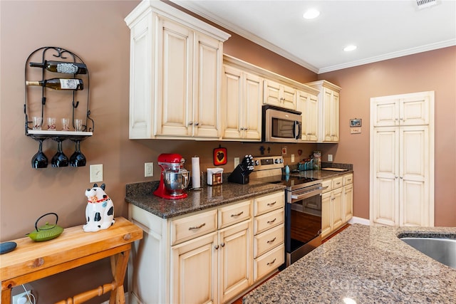 kitchen with stainless steel appliances, crown molding, dark stone counters, recessed lighting, and a sink