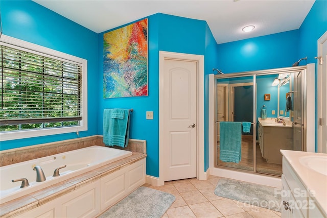 full bathroom with a garden tub, a stall shower, vanity, tile patterned floors, and baseboards