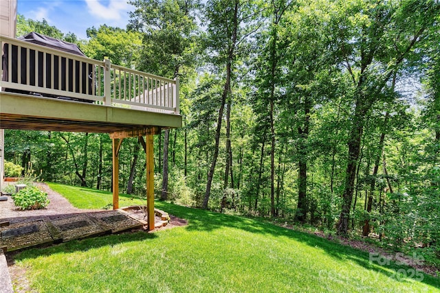 view of grassy yard featuring a deck
