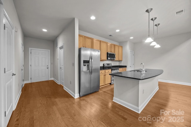 120F Steinbeck Way, Mooresville, NC 28117 - kitchen featuring stainless steel appliances, a sink, dark countertops, light wood-style floors, and backsplash