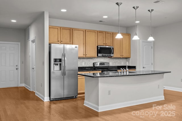 120F Steinbeck Way, Mooresville, NC 28117 - kitchen featuring appliances with stainless steel finishes, light wood-style floors, backsplash, a center island with sink, and pendant lighting
