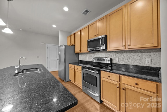 120F Steinbeck Way, Mooresville, NC 28117 - kitchen with stainless steel appliances, a sink, light wood finished floors, and backsplash
