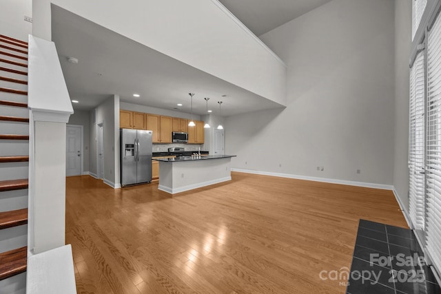 120F Steinbeck Way, Mooresville, NC 28117 - unfurnished living room featuring light wood-style flooring, baseboards, recessed lighting, and stairs