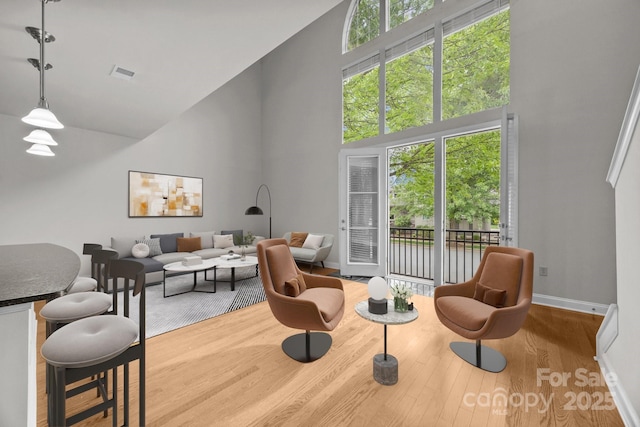 120F Steinbeck Way, Mooresville, NC 28117 - living room featuring a high ceiling, wood finished floors, and baseboards