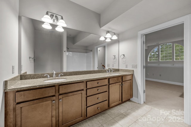 120F Steinbeck Way, Mooresville, NC 28117 - bathroom with double vanity, tile patterned flooring, baseboards, and a shower