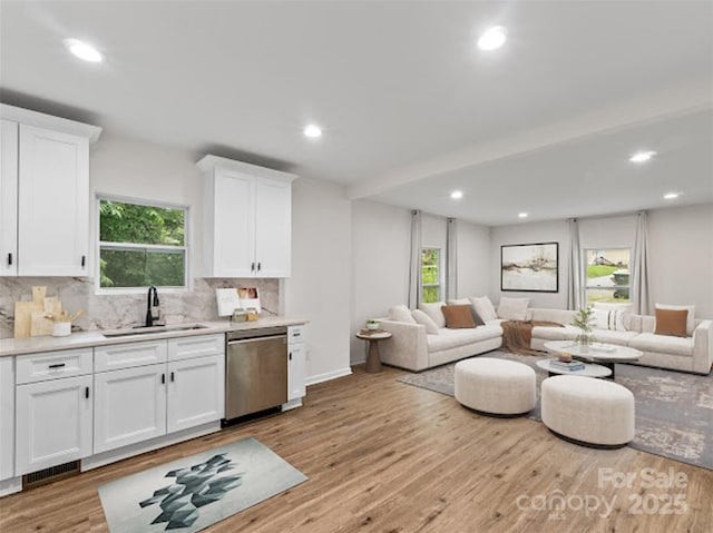 60 Valley St NW, Concord, NC 28025 - kitchen with stainless steel dishwasher, open floor plan, a sink, tasteful backsplash, and recessed lighting