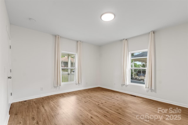 60 Valley St NW, Concord, NC 28025 - unfurnished room with wood finished floors, baseboards, and a smoke detector