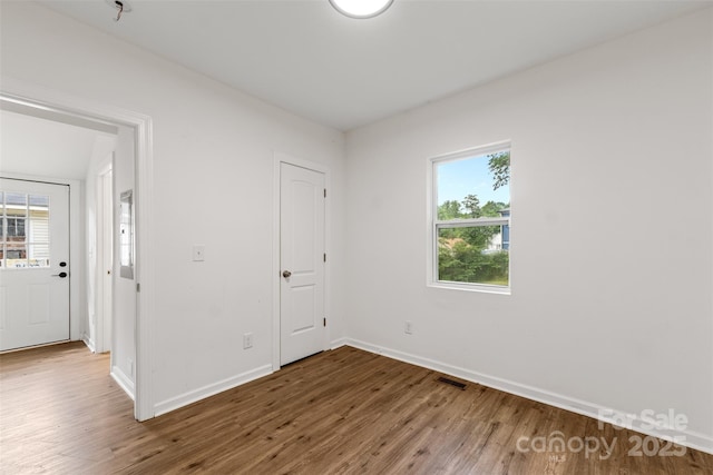 60 Valley St NW, Concord, NC 28025 - unfurnished bedroom with wood finished floors and baseboards