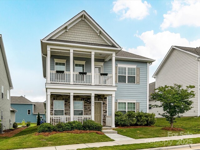 134 Kerri Dawn Ln Unit 117, Locust, NC 28097 - view of front of home featuring covered porch, a balcony, and a front lawn
