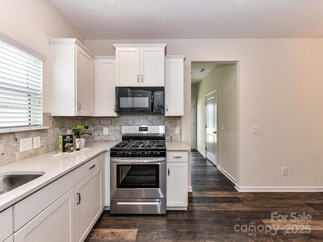134 Kerri Dawn Ln Unit 117, Locust, NC 28097 - kitchen with black microwave, stainless steel gas range oven, white cabinetry, backsplash, and dark wood-style flooring
