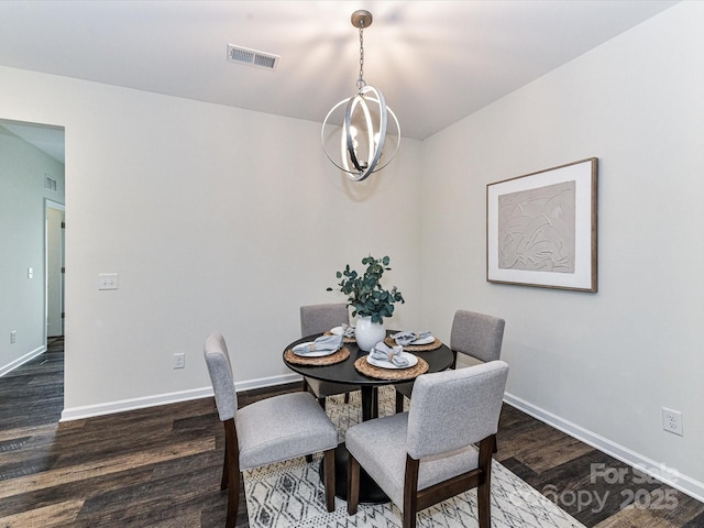 134 Kerri Dawn Ln Unit 117, Locust, NC 28097 - dining space with dark wood-type flooring, baseboards, and a chandelier
