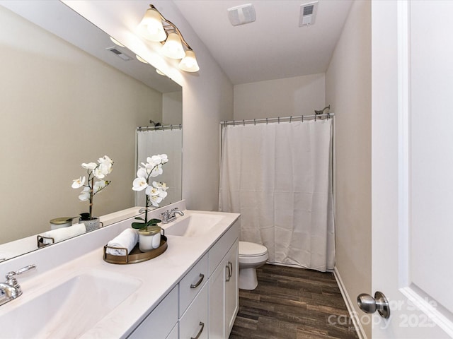 134 Kerri Dawn Ln Unit 117, Locust, NC 28097 - full bathroom with double vanity, wood finished floors, toilet, and a shower with shower curtain