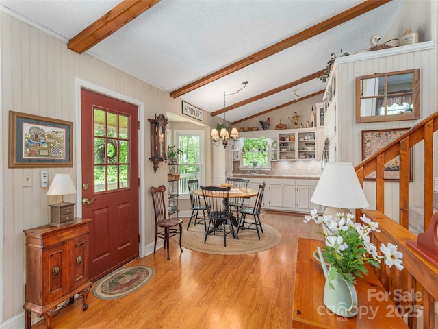 227 Soco Acres Rd, Maggie Valley, NC 28751 - dining space featuring light wood-style floors, a textured ceiling, a chandelier, and stairs