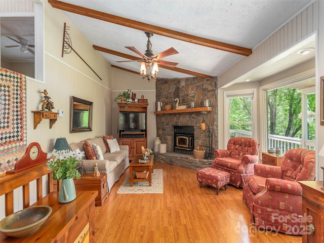 227 Soco Acres Rd, Maggie Valley, NC 28751 - living area with ceiling fan, wood finished floors, a textured ceiling, and a wood stove