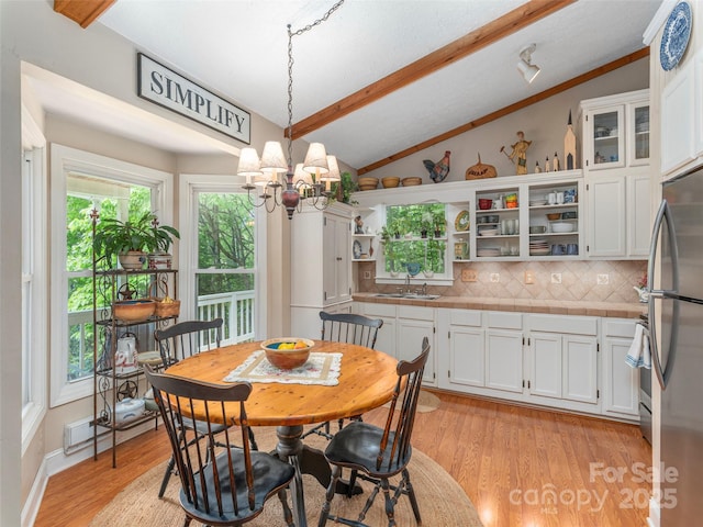 227 Soco Acres Rd, Maggie Valley, NC 28751 - dining space featuring a chandelier, light wood-style floors, and baseboard heating