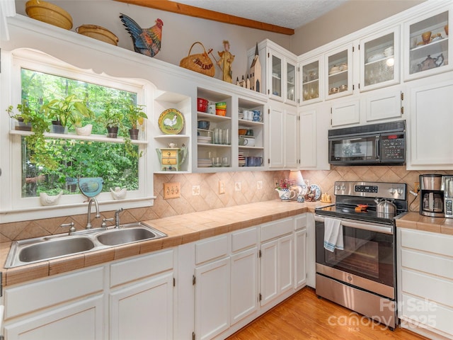 227 Soco Acres Rd, Maggie Valley, NC 28751 - kitchen with electric stove, black microwave, a sink, and white cabinets