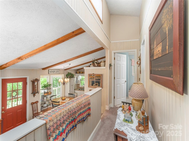 227 Soco Acres Rd, Maggie Valley, NC 28751 - foyer with beamed ceiling, a textured ceiling, light carpet, and wooden walls