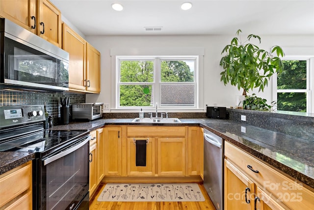 24 Browndale Rd, Asheville, NC 28805 - kitchen featuring appliances with stainless steel finishes, a sink, recessed lighting, light wood-type flooring, and backsplash