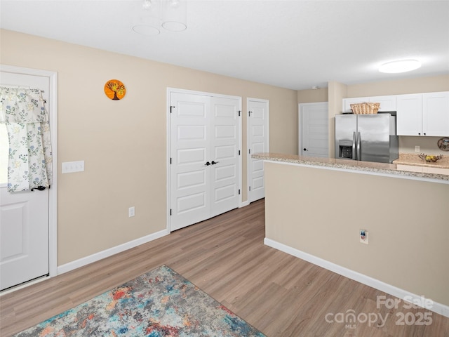 87 Markley Dr, Flat Rock, NC 28731 - kitchen featuring stainless steel fridge with ice dispenser, light wood-style floors, baseboards, and white cabinets