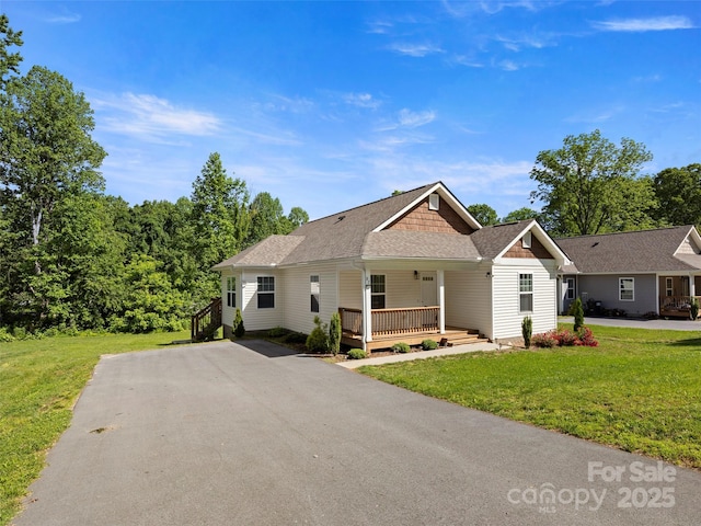 87 Markley Dr, Flat Rock, NC 28731 - view of front facade featuring a porch, a front lawn, roof with shingles, and driveway