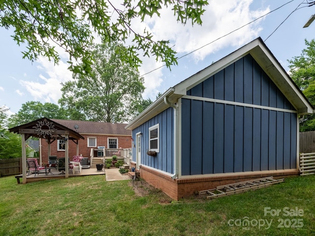 back of property featuring a gazebo and board and batten siding