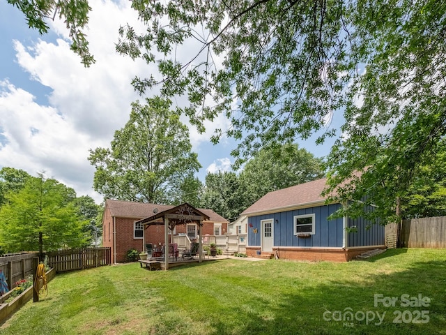 view of yard featuring a gazebo and an outbuilding