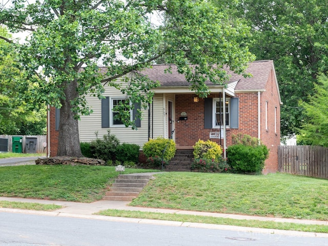 view of front of house featuring roof with shingles and brick siding