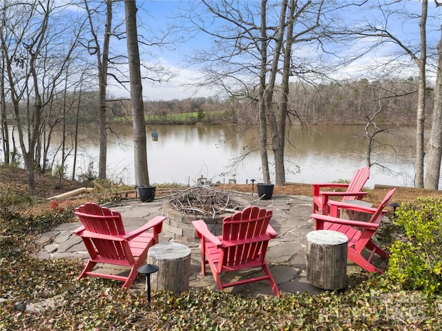 3115 Duck Point Dr, Monroe, NC 28110 - view of patio with an outdoor fire pit, a water view, and a view of trees