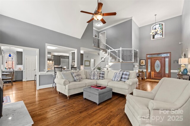 3115 Duck Point Dr, Monroe, NC 28110 - living area featuring high vaulted ceiling, a chandelier, stairs, ornamental molding, and ceiling fan