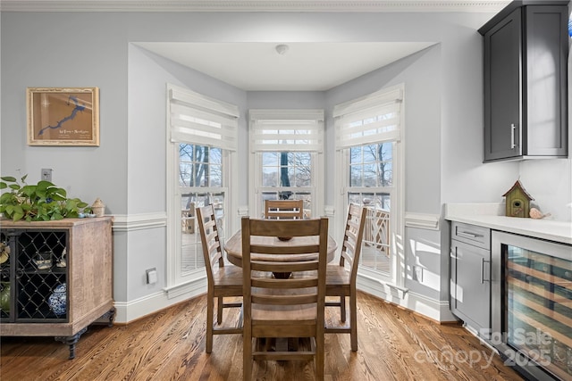 3115 Duck Point Dr, Monroe, NC 28110 - dining area with beverage cooler, wood finished floors, a dry bar, and baseboards