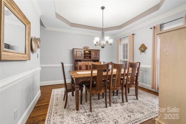 3115 Duck Point Dr, Monroe, NC 28110 - dining area featuring a chandelier, dark wood-type flooring, a tray ceiling, ornamental molding, and baseboards