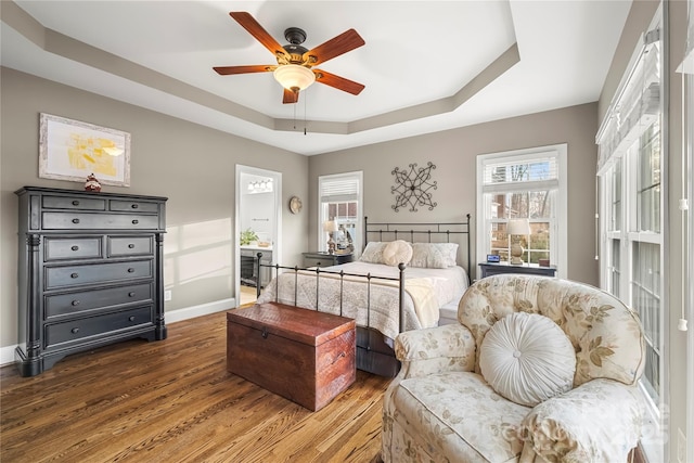3115 Duck Point Dr, Monroe, NC 28110 - bedroom featuring a tray ceiling, wood finished floors, baseboards, and ceiling fan