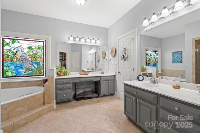 3115 Duck Point Dr, Monroe, NC 28110 - bathroom with tile patterned flooring, a garden tub, and vanity