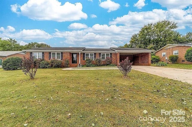 ranch-style house featuring concrete driveway, brick siding, a front yard, and an attached carport