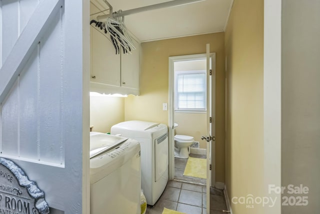 laundry room featuring independent washer and dryer, cabinet space, light tile patterned floors, and baseboards