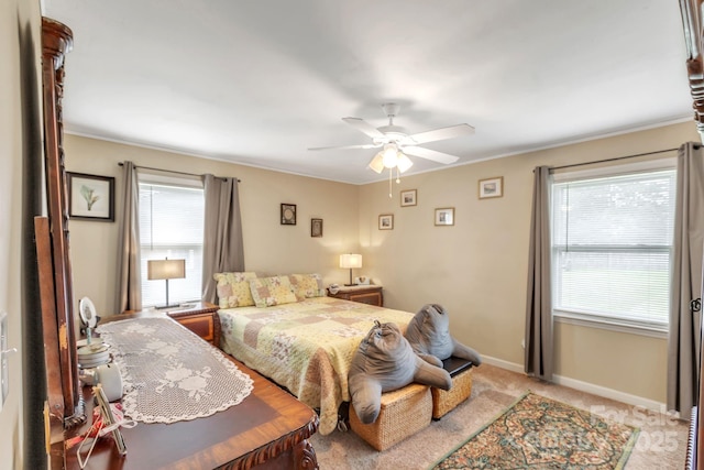 bedroom with baseboards, light carpet, ornamental molding, and ceiling fan