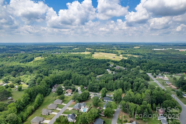 aerial perspective of suburban area with a heavily wooded area