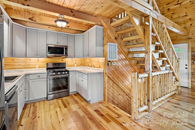 2097 Pinnacle Pkwy Unit 14, Union Mills, NC 28167 - kitchen featuring stainless steel appliances, wooden walls, light wood finished floors, light stone counters, and wood ceiling with exposed beams