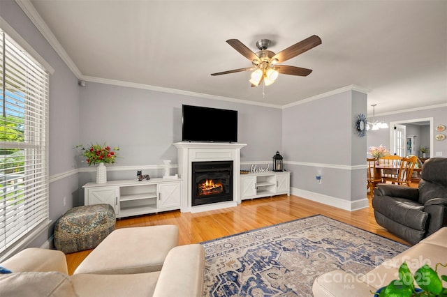 136 Coventry Ln, Forest City, NC 28043 - living area with wood finished floors, ceiling fan, crown molding, a glass covered fireplace, and baseboards